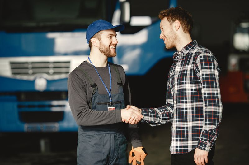 Service writer with a customer at an auto shop counter